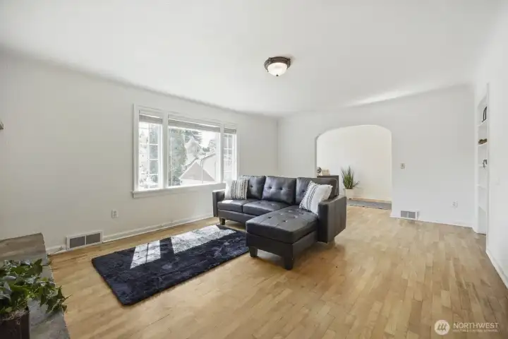 Another colossal room, with built-in shelving nook on the right and archway to den/office area