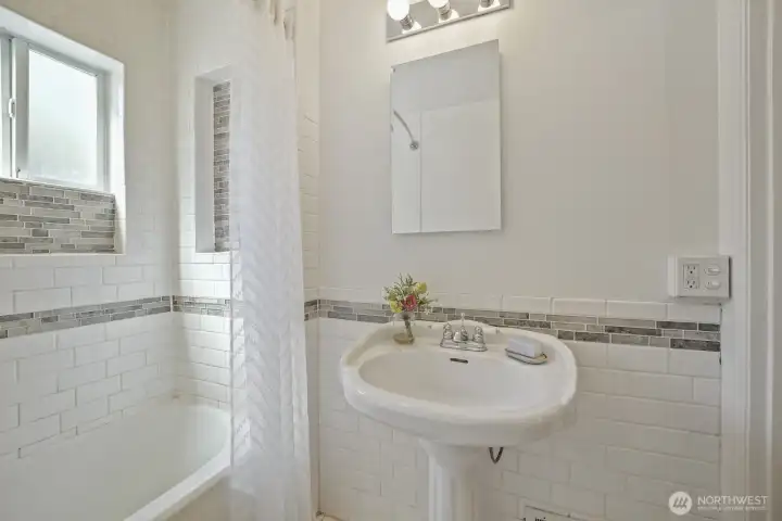 Another look at the main floor bath- stylish pedestal sink, mirrored medicine cabinet & updated toilet
