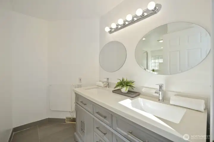 Fully updated lower, full bathroom with double sinks and solid surface
