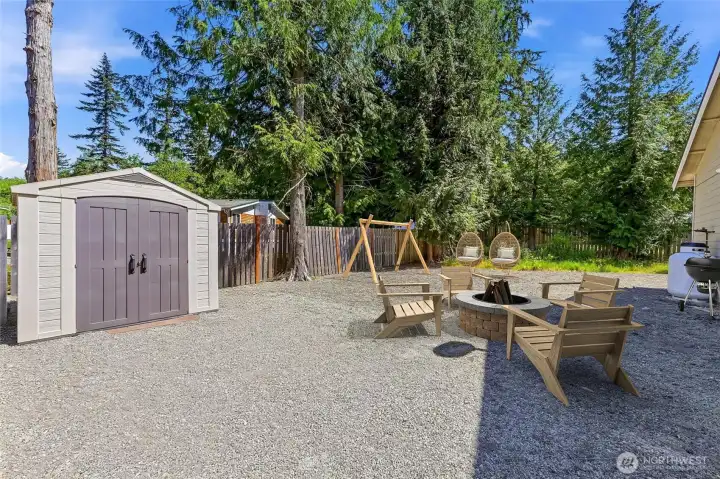 Huge side yard virtually staged with swing set and firepit. This space has so many posibilities