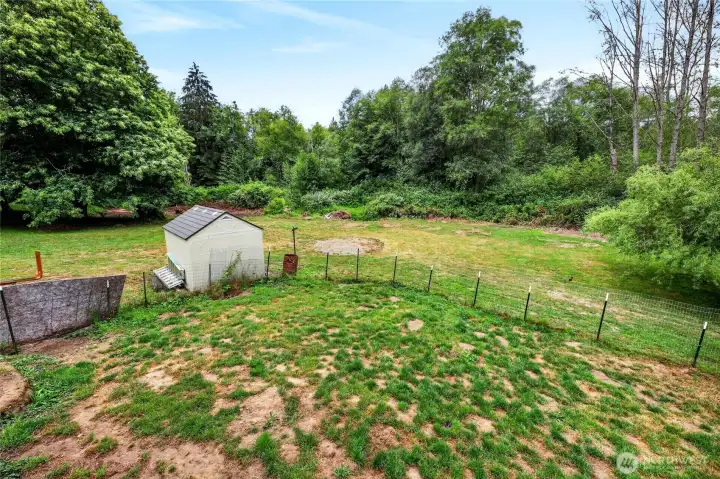 Portion of back yard is fully fenced for Dogs