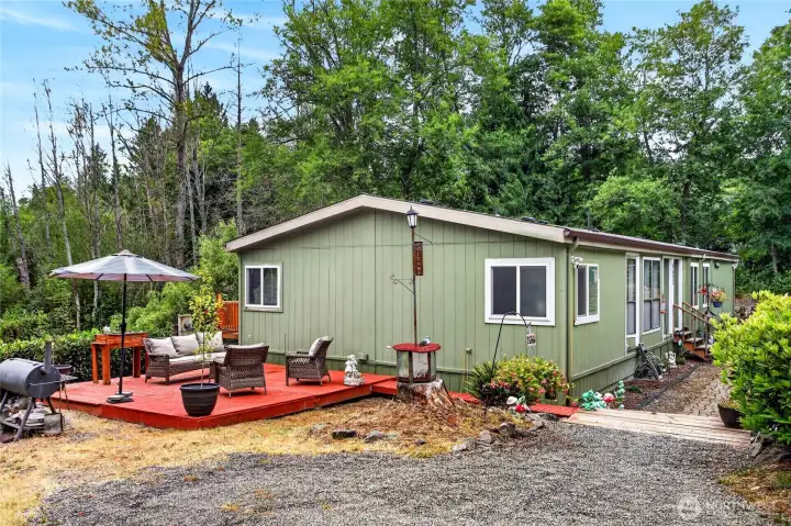 Side of house with deck and lots of parking for all types of vehicles including RV's