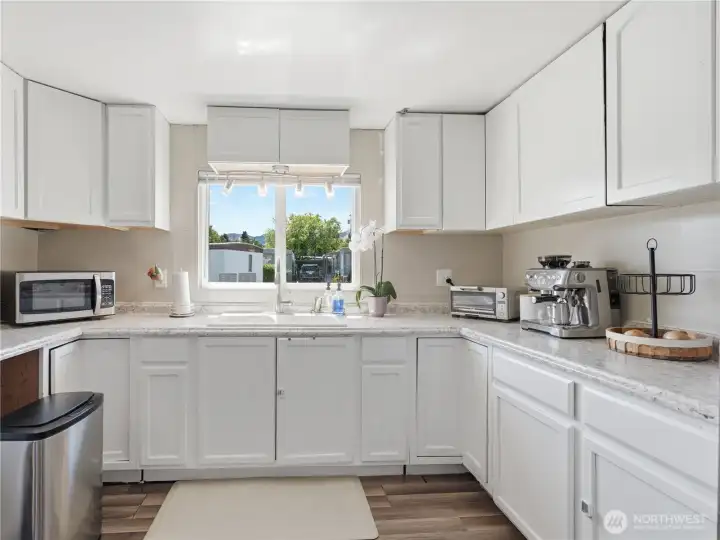 Renovated kitchen with updated cabinetry, countertops, and modern fixtures. Renovated kitchen with updated cabinetry, countertops, and modern fixtures.