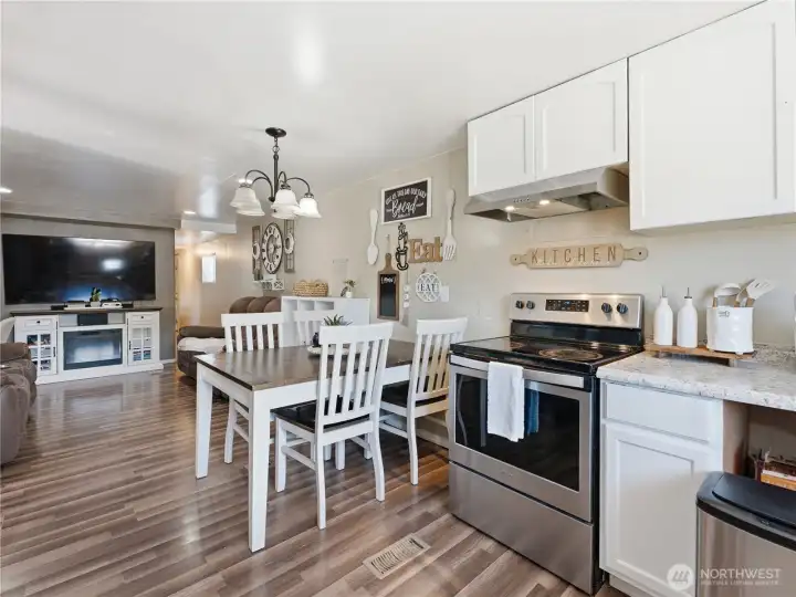Kitchen with updated appliances and convenient dining area. Kitchen with updated appliances and convenient dining area.