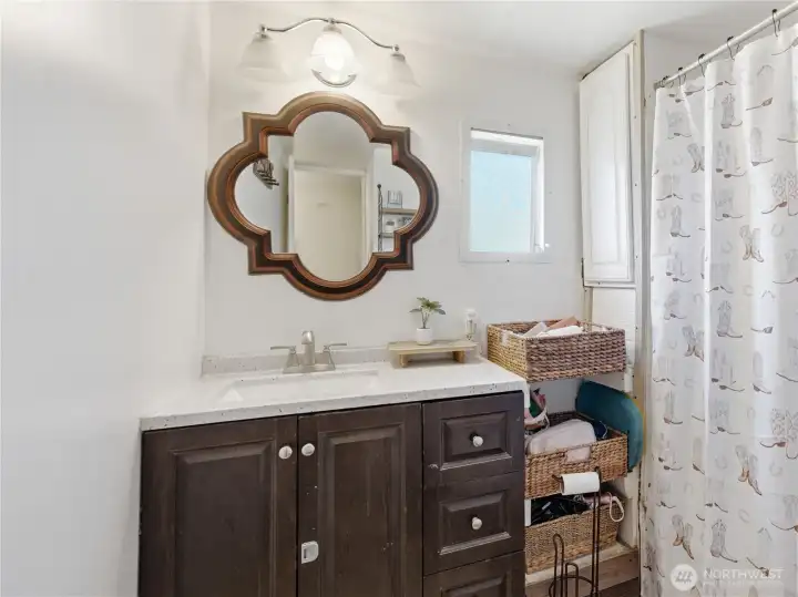 Full bathroom with updated vanity, fixtures, and tub/shower combination. Full bathroom with updated vanity, fixtures, and tub/shower combination.