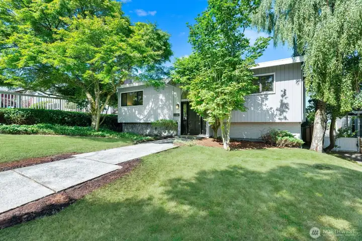 Welcoming entry, tucked back from the quiet street with mature landscaping for added privacy.