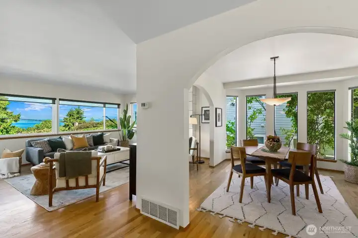 Living room and dining rooms share a lovely view of Puget Sound and Olympic Mountains.