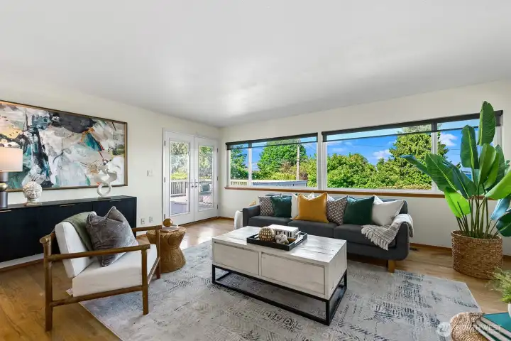 French doors lead to a spacious deck. Western facing windows have sun shades.