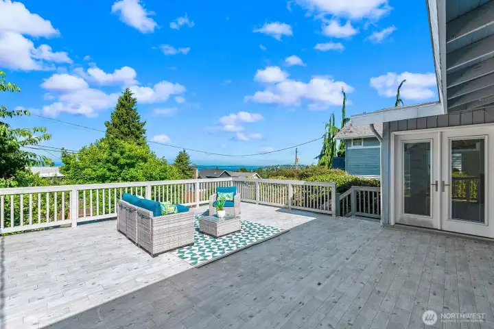 xpansive entertainment deck with Sound and Mountain views