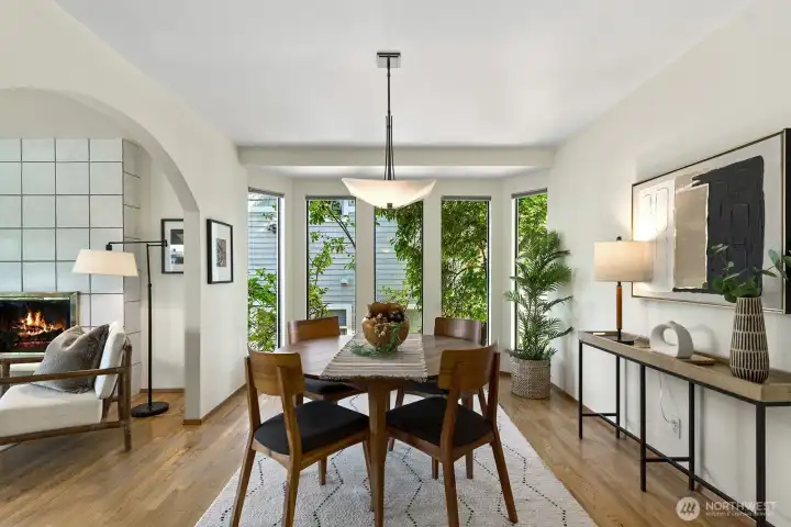 Formal dining area with oversized windows and seamless flow to the living room