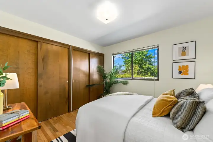 Sun-filled bedroom with generous closet space and hardwood floors