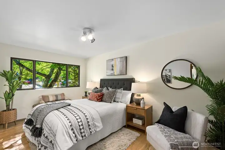 Peaceful primary bedroom with tree filtered morning light