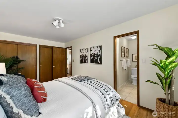 Comfortable primary suite with hardwood floors and private ensuite bath