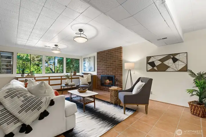 Inviting recreation space with built in wall storage cabinets, wood burning fireplace--perfect for relaxing or entertaining