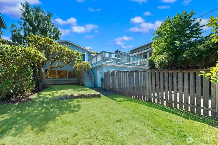Private, level backyard with mature landscaping and room to play or garden