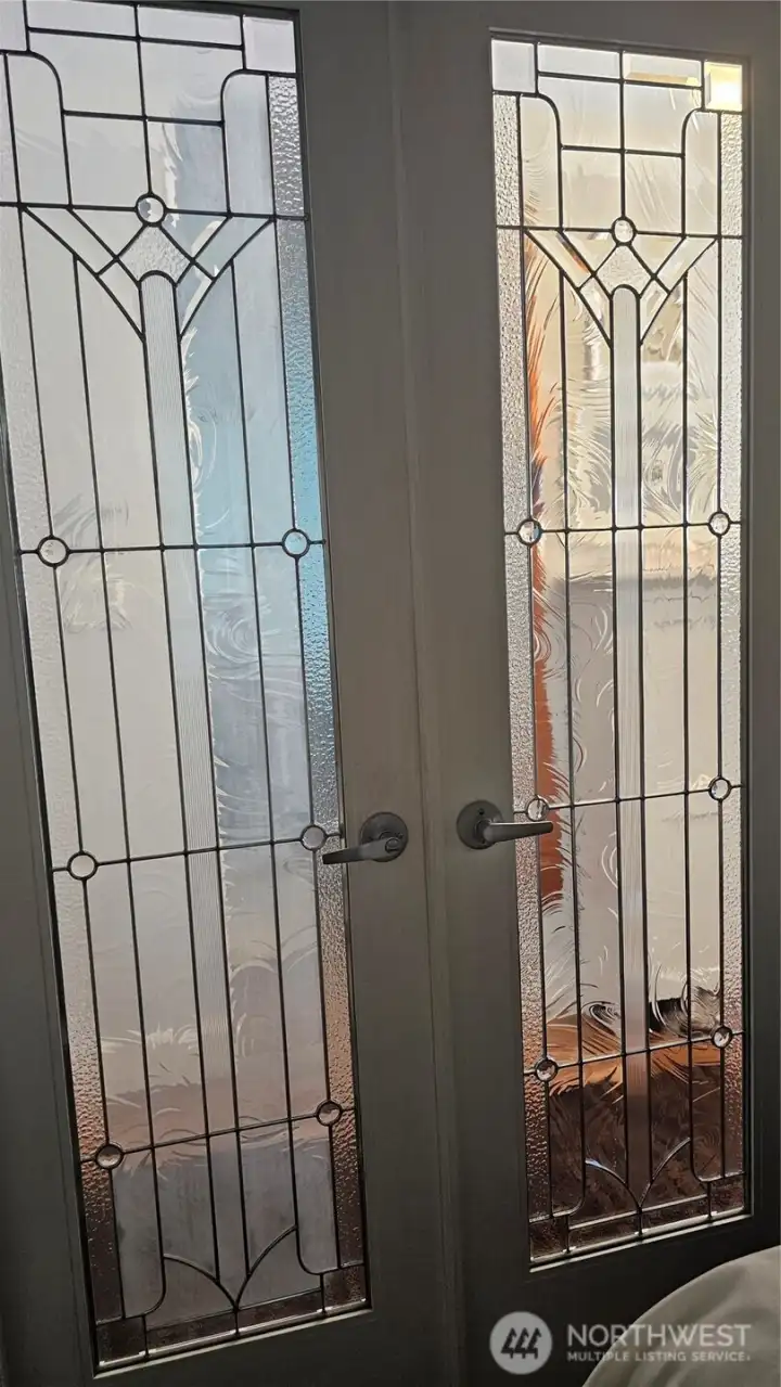 Bedroom lead glass door into hallway