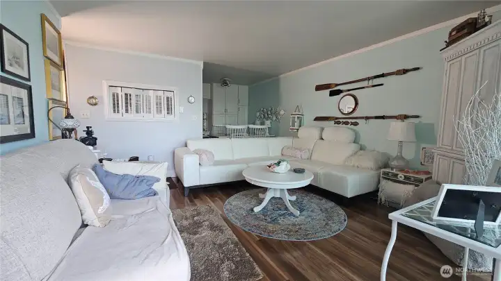 Living room looking back at dining area and kitchen