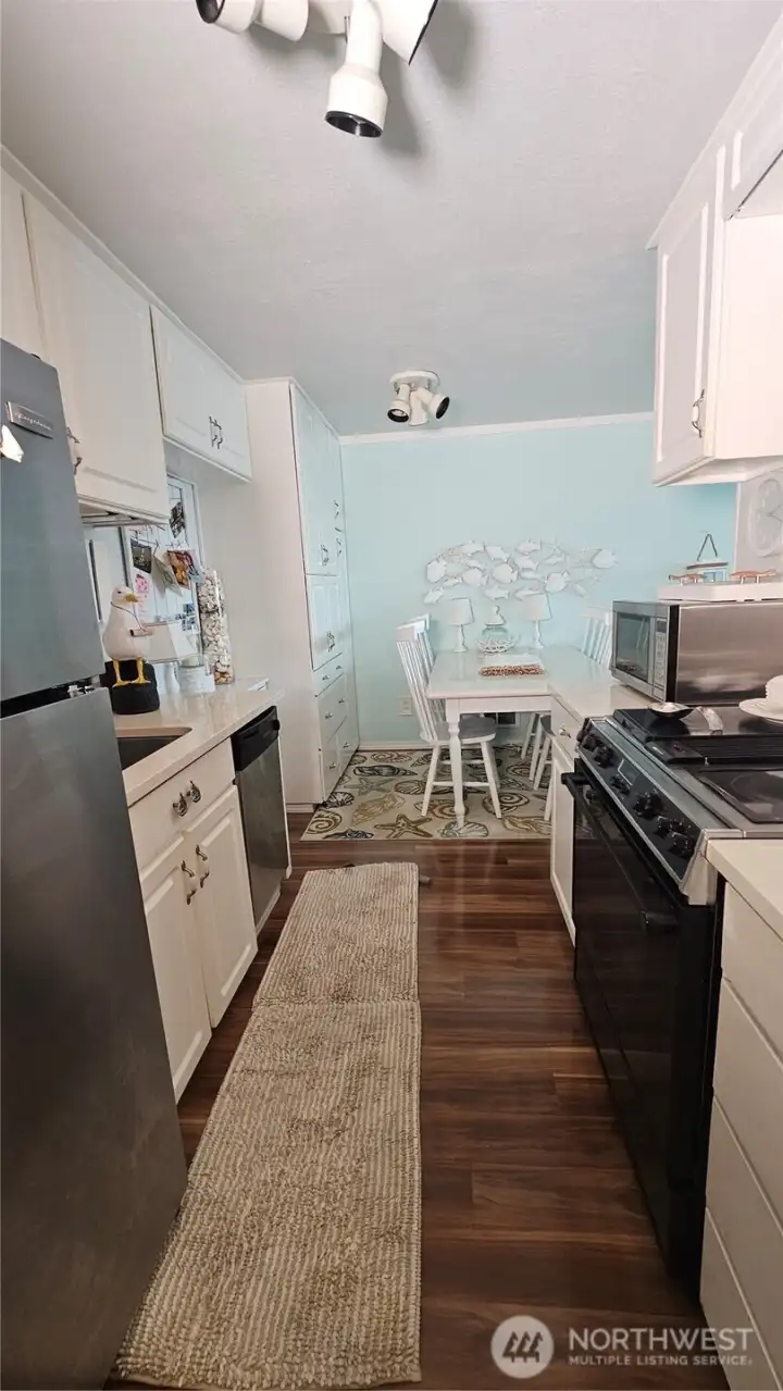 Galley kitchen walk thru from hallway to dining area