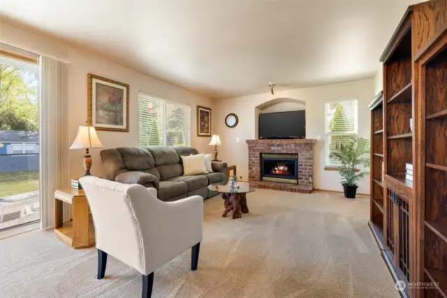The family room features a cozy gas fireplace. The utility room and garage entrance are to the right.