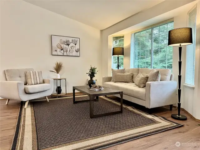 The living room features vaulted ceilings and large windows.