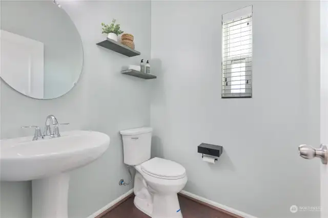 Main floor powder room with window and privacy fan