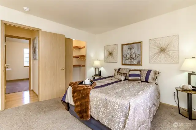 This view of the primary bedroom highlights the spacious walk-in closet, offering ample storage space. Directly across the hall is bedroom #3, making it ideal for family members or guests while maintaining privacy for the primary suite