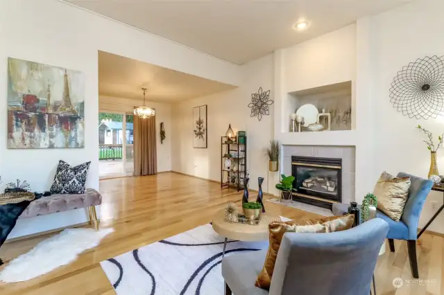 This view showing the living room, dining room and large slider to the covered back deck and backyard.