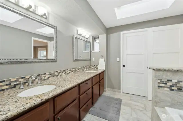 owners bathroom looking at doors to walkin closet