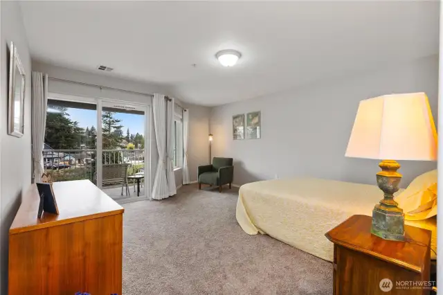 Double doors separate the primary suite with deck access to covered, expansive deck.