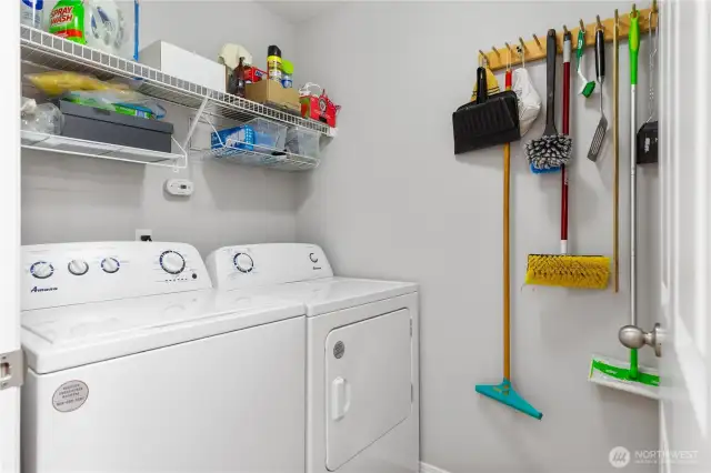 Laundry room with sink and new washer and dryer.