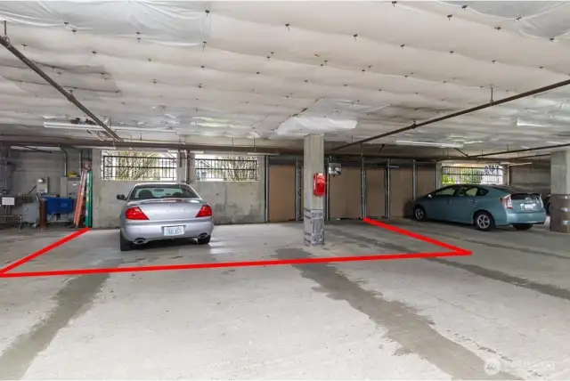 Two extra large parking spaces with storage in front.