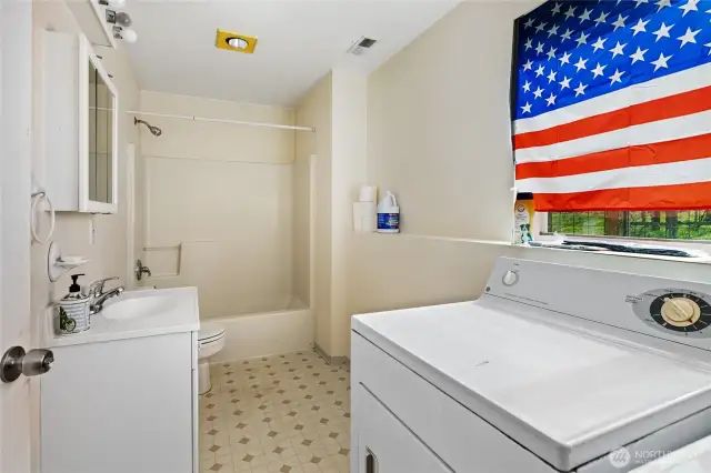 Full bathroom and laundry area in shop