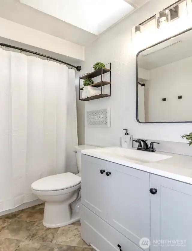 Fully remodeled hall bathroom.