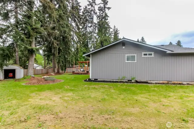Side view of the back yard, storage shed and deck.