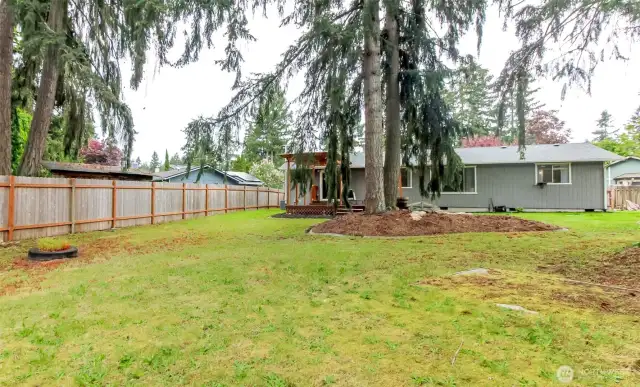 Deep yard with plenty of room for gardening or playing.