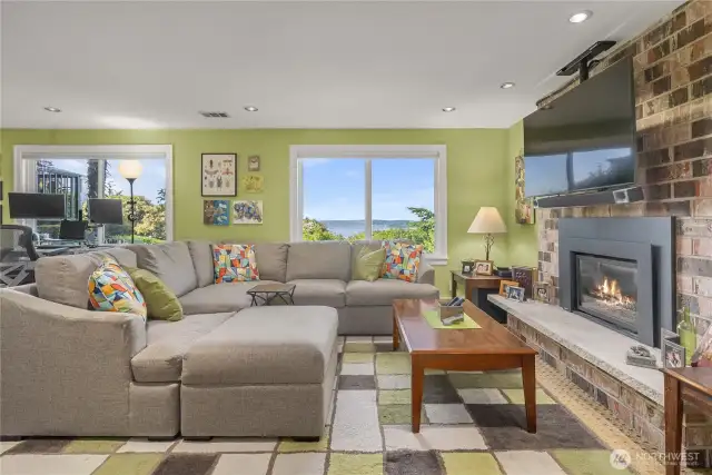 A additional view of the Family Room showing the View and the 2nd Gas-Log Fireplace. Notice the Recessed Lighting and Classic Brick Fireplace Surround providing a timeless aesthetic; it’s warm, cozy and comfortable.
