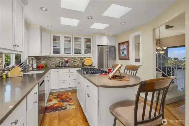 Just look at this Island Kitchen!!! Fully Updated with Quartz, New Soft-Close Cabinets/Drawers with Undermount Lighting, Polished Glass Mosaic Backsplash, Skylights, SS KitchenAid Appliances (including a 5-Burner gas Range) and a Double Pantry Cabinet with Pull-Outs! It’s a Culinary Delight!!