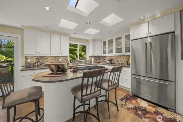 Your gourmet kitchen features Modern White Cabinetry throughout, with plenty of storage above and below the counters, for all of your cooking essentials. This Quartz Island Breakfast Bar is great for gathering around during meal prep, and the Back Door leading to the Wrap-Around deck provides a quick path for outdoor grilling.….so close to the kitchen!