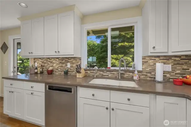 A closer view of the Kitchen and the High-Quality, Blanco Undermount (Granite) sink that looks over the backyard. The bright window adds natural light as you look out over the Park-like Setting; your own back yard, a tranquil and inviting scene. The combination of these Blue Views off the Front of the Home and Natural, Lush Green Views off the back create your own personal retreat! It’s very special and just so appealing.