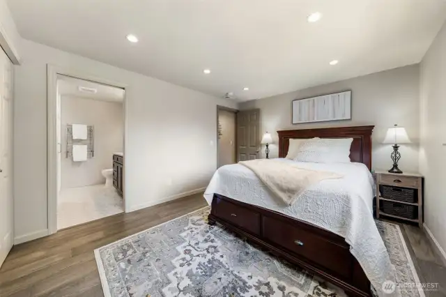 The Primary Suite offers both comfort and convenience with direct access to the ensuite bathroom. Take note of the engineered hardwood floors that carry through the home for a cohesive, elevated feel.