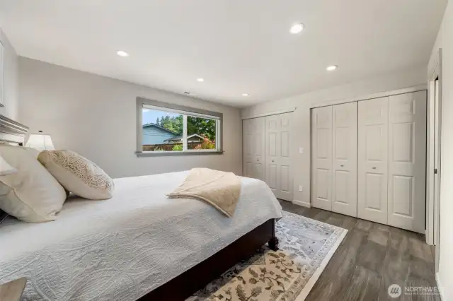 Wake up to peaceful backyard views in this serene Primary Suite, complete with dual closets and custom built-in storage units to keep everything neatly tucked away. A discreet pocket door (with full length mirror) allows one person to get ready in privacy while the other sleeps undisturbed.