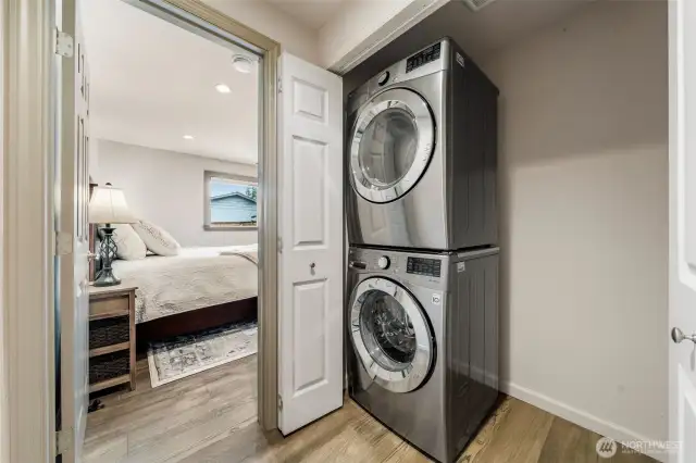 Behind sleek double doors, you'll discover the full-size stacked washer and dryer offer modern convenience—plus extra side space perfect for shelving or laundry essentials.