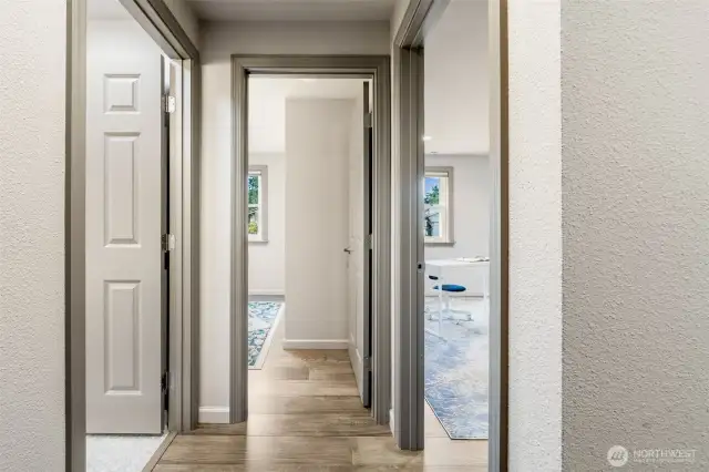 This bright hallway leads to the full bath, second and third bedrooms or office—creating an intuitive, functional layout for everyday living.