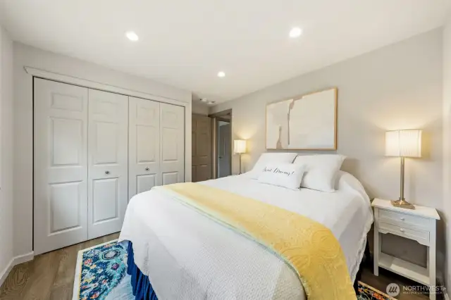 Bedroom Two offers a bright, welcoming space with recessed lighting, a generous closet with an updated clothing system, and classic six-panel doors. Ideal for guests or a personal retreat with functional, thoughtful touches throughout.