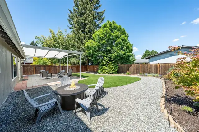 The covered patio sets the scene for delightful al fresco dining, with room for a nearby firepit beckons guests to gather and enjoy evenings under the stars.