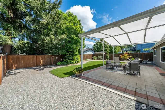 Experience seamless indoor-outdoor living in this contemporary landscape, where a beautifully integrated covered patio transitions effortlessly into lush garden spaces.