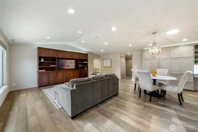 The great room features a thoughtfully placed guest closet near the entry for convenient storage. A full wall of custom cabinets and magnet-to-open, safe drawers offer ample space to organize everything from dinnerware to daily essentials.