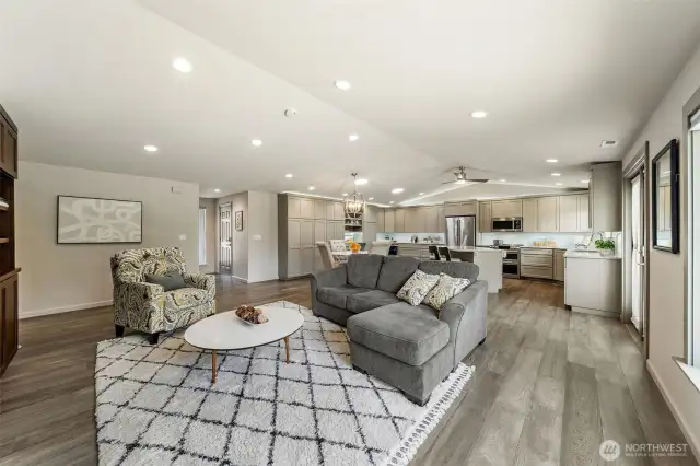 This open-concept great room flows seamlessly with beautifully engineered hardwood floors and a refined trim package add warmth and cohesive style throughout the home.