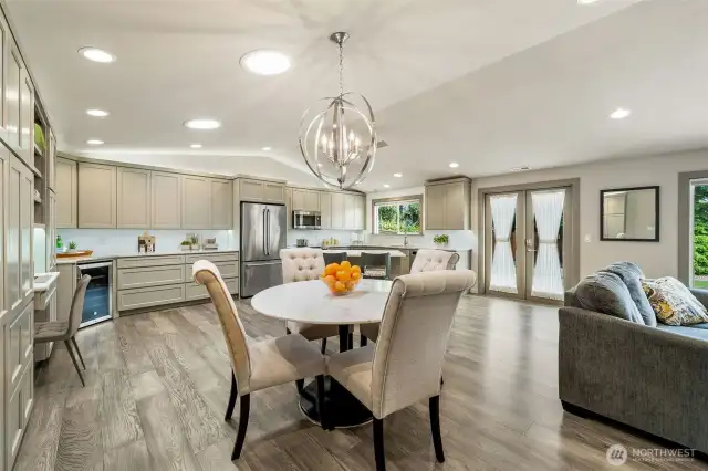 Bathed in natural light from abundant skylights, the open-concept living, dining, and kitchen areas create an inviting atmosphere. Don't miss the versatile desk nook, offering convenience and flexibility for both entertaining and daily tasks.