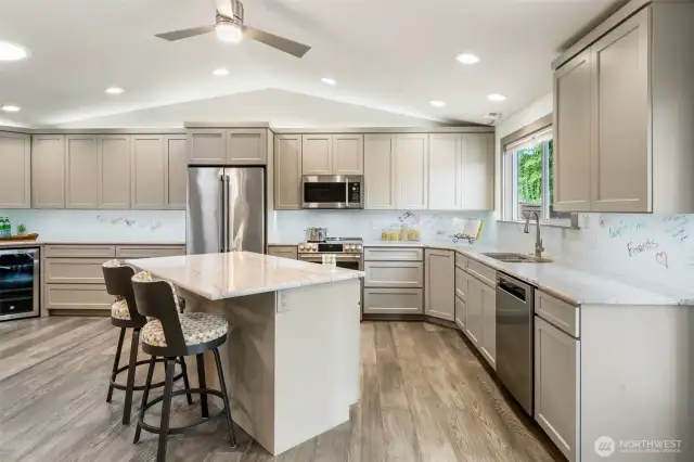 This chef’s kitchen features top-of-the-line GE Café appliances, elegant Quartzite countertops, and a sleek, modern backsplash that adds a polished touch. And here’s the fun part—grab a dry erase marker and leave a cheerful note or tonight’s menu right on the backsplash!